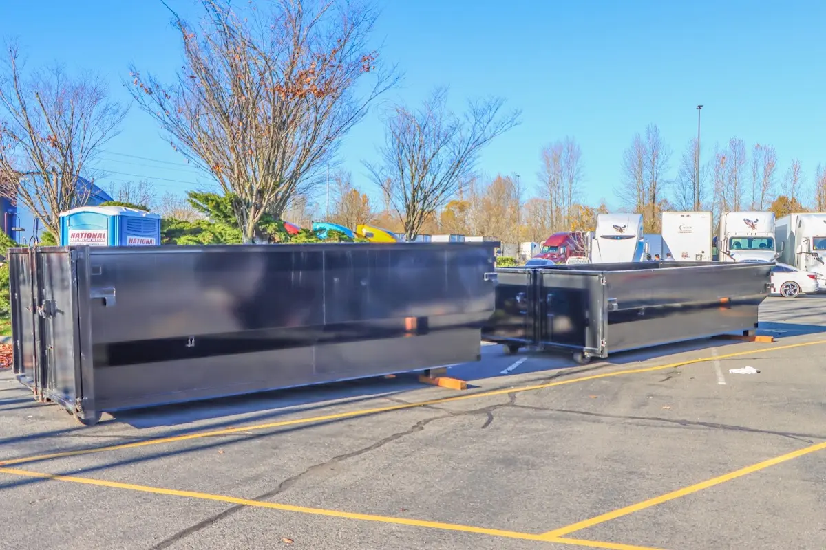 Professional dumpster rental service with roll-off container on residential driveway in Hemet